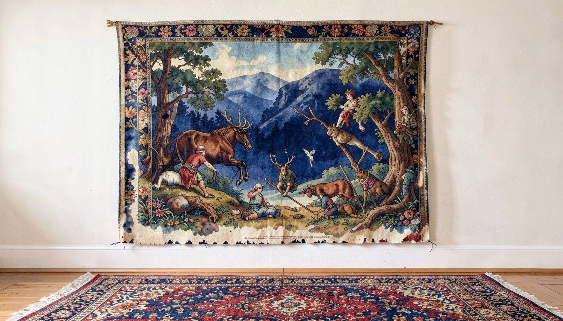 A richly colored tapestry wall hanging with an Old World hunting scene, displayed above a coordinating rug