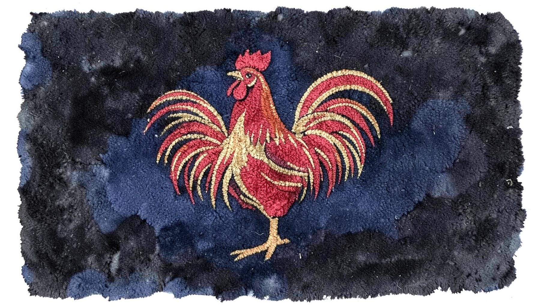 A woven olefin rug featuring a proud rooster motif in bold reds and golds against a dark background